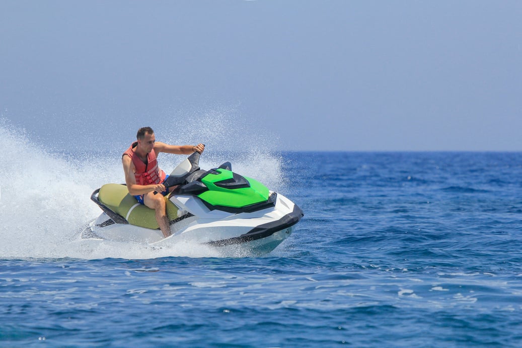 Tourists enjoy driving jetski on the ocean